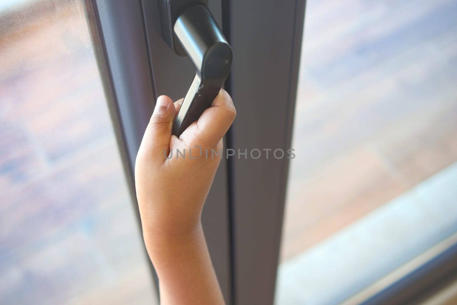 A child reaches for a door handle, eager to enter the room.