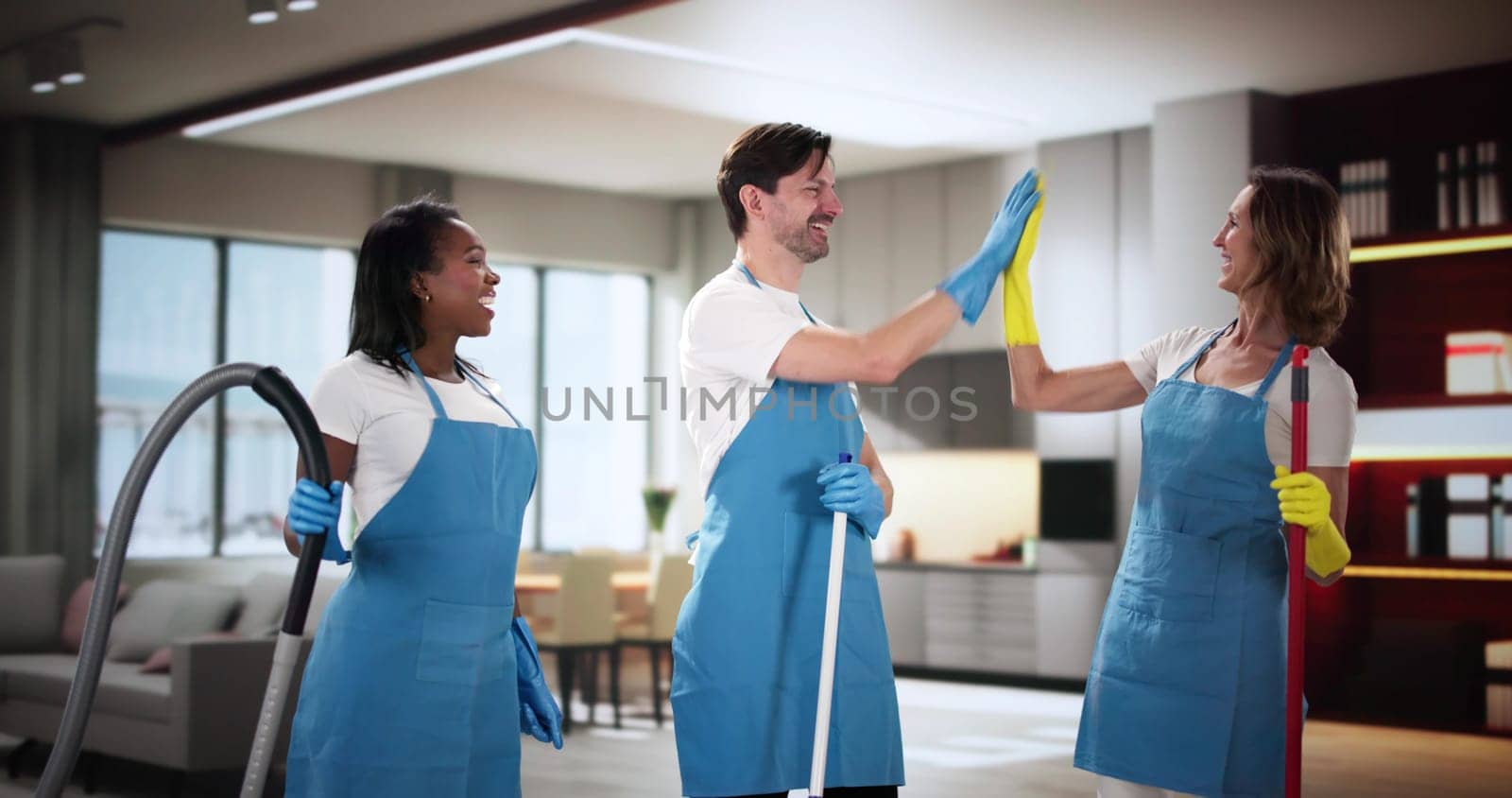 Smiling janitor team giving high five in living room