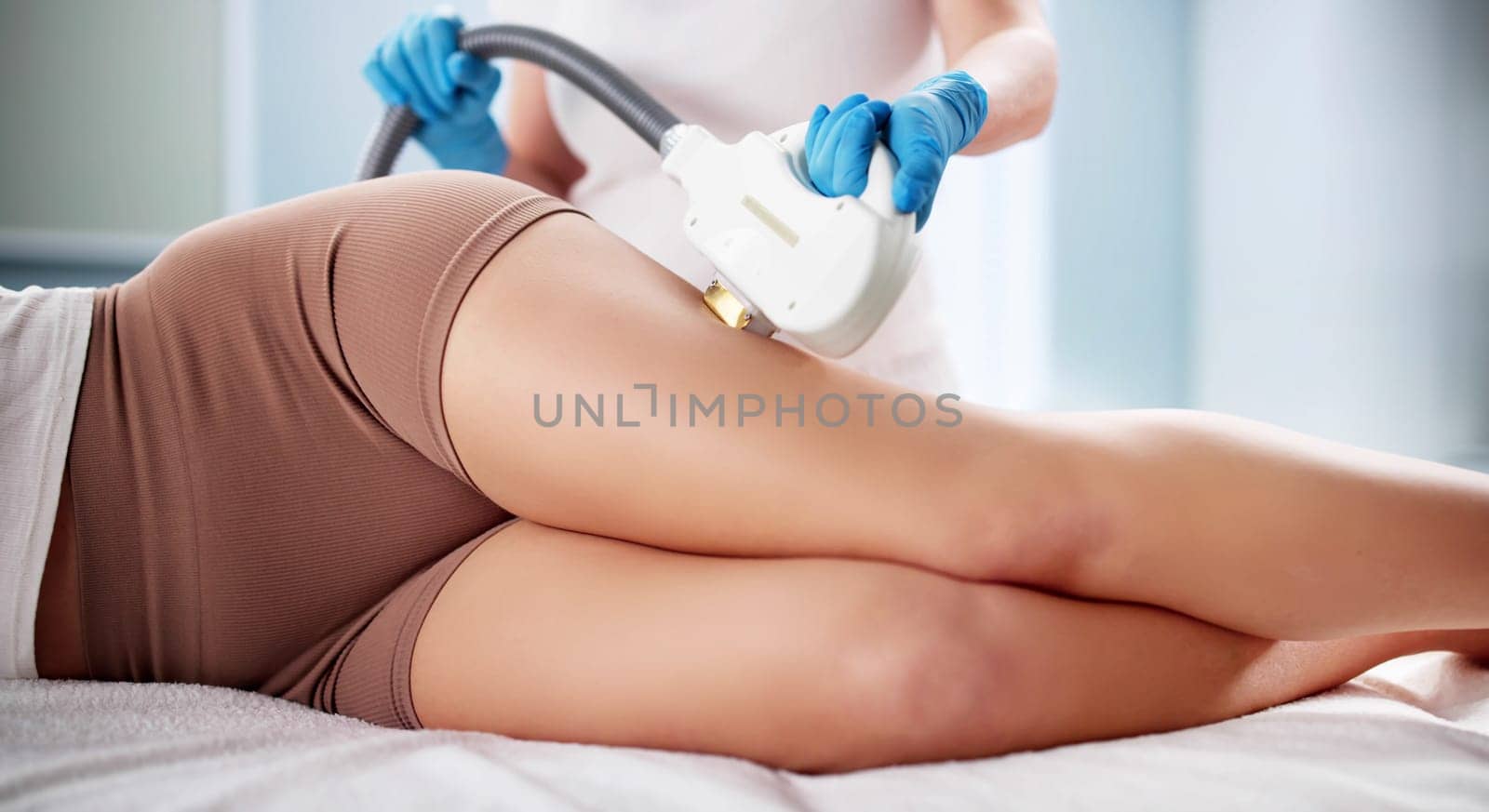 Dermatologist Performing Laser Hair Removal Treatment on a Customer