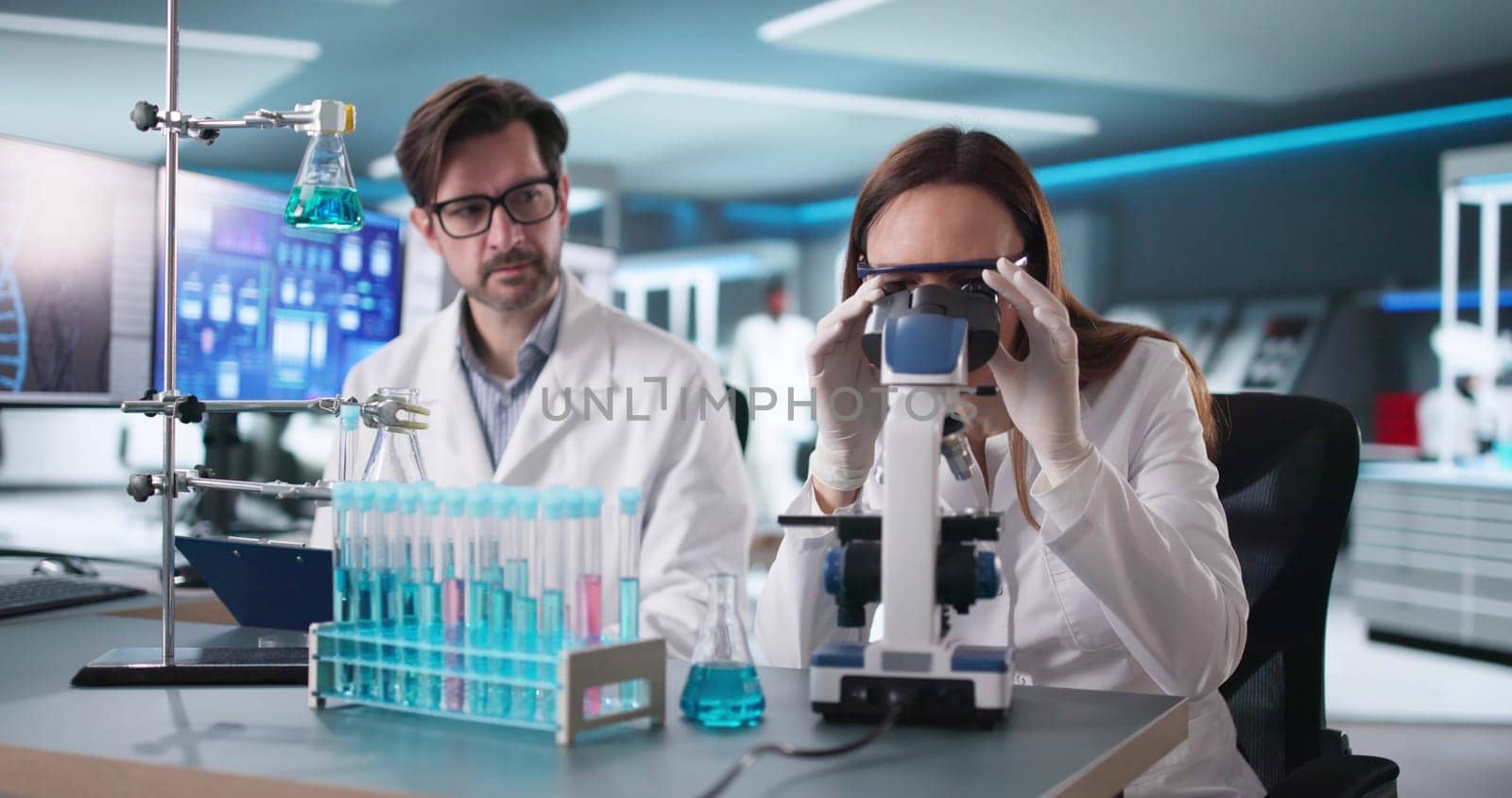 Researcher Couple Analyzing Data in High-Tech Science Lab Setting