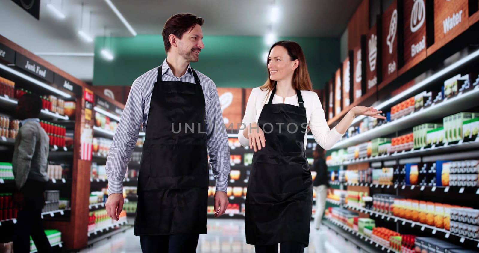 Teaching a Woman the Ropes at the Retail Supermarket Assistant.