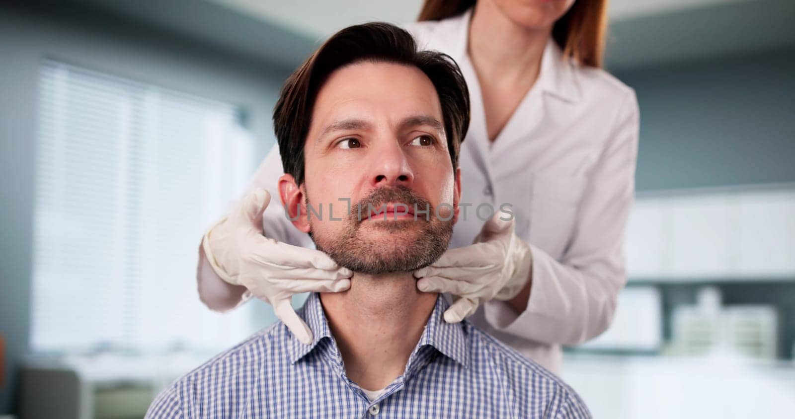 The Doctor carefully palpates the thyroid gland during physical exam