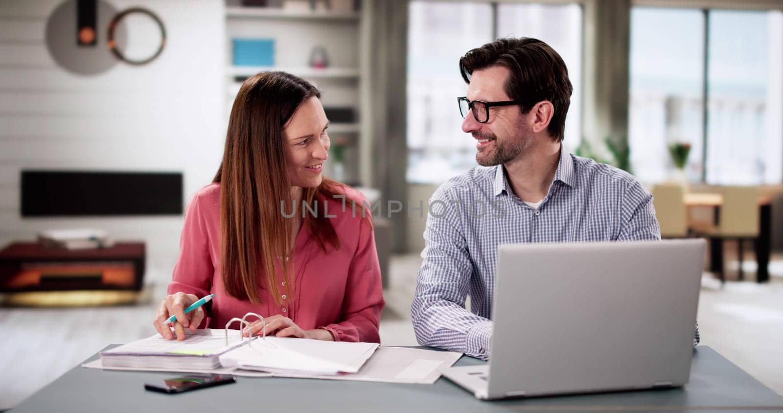 Happy Couple Planning Retirement Finances Together: Budget, Invest, Save.