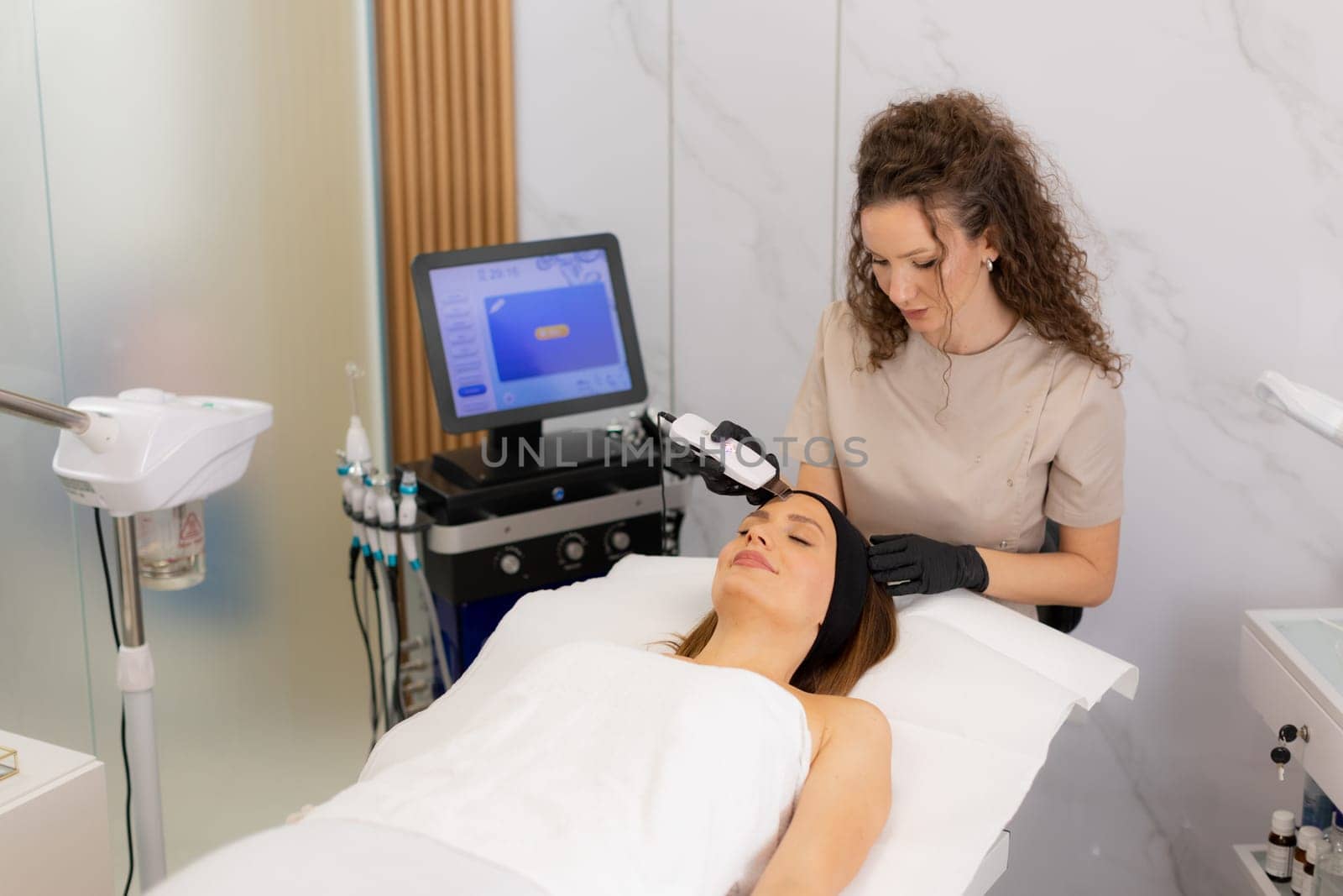A serene setting showcases a skilled practitioner using an ultrasonic facial massager on a client's skin, promoting deep cleansing and relaxation for a radiant complexion.