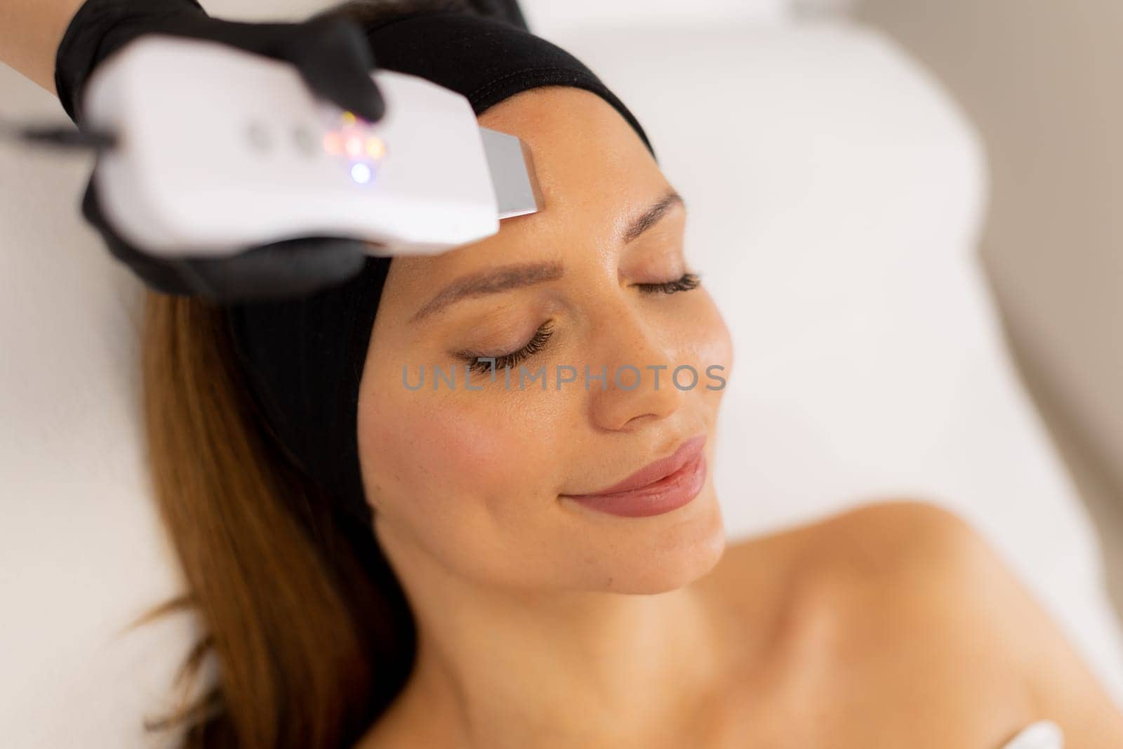 Soothing vibrations from the ultrasonic facial massager create a rejuvenating experience as the expert skincare professional cleanses and revitalizes the client’s radiant complexion.