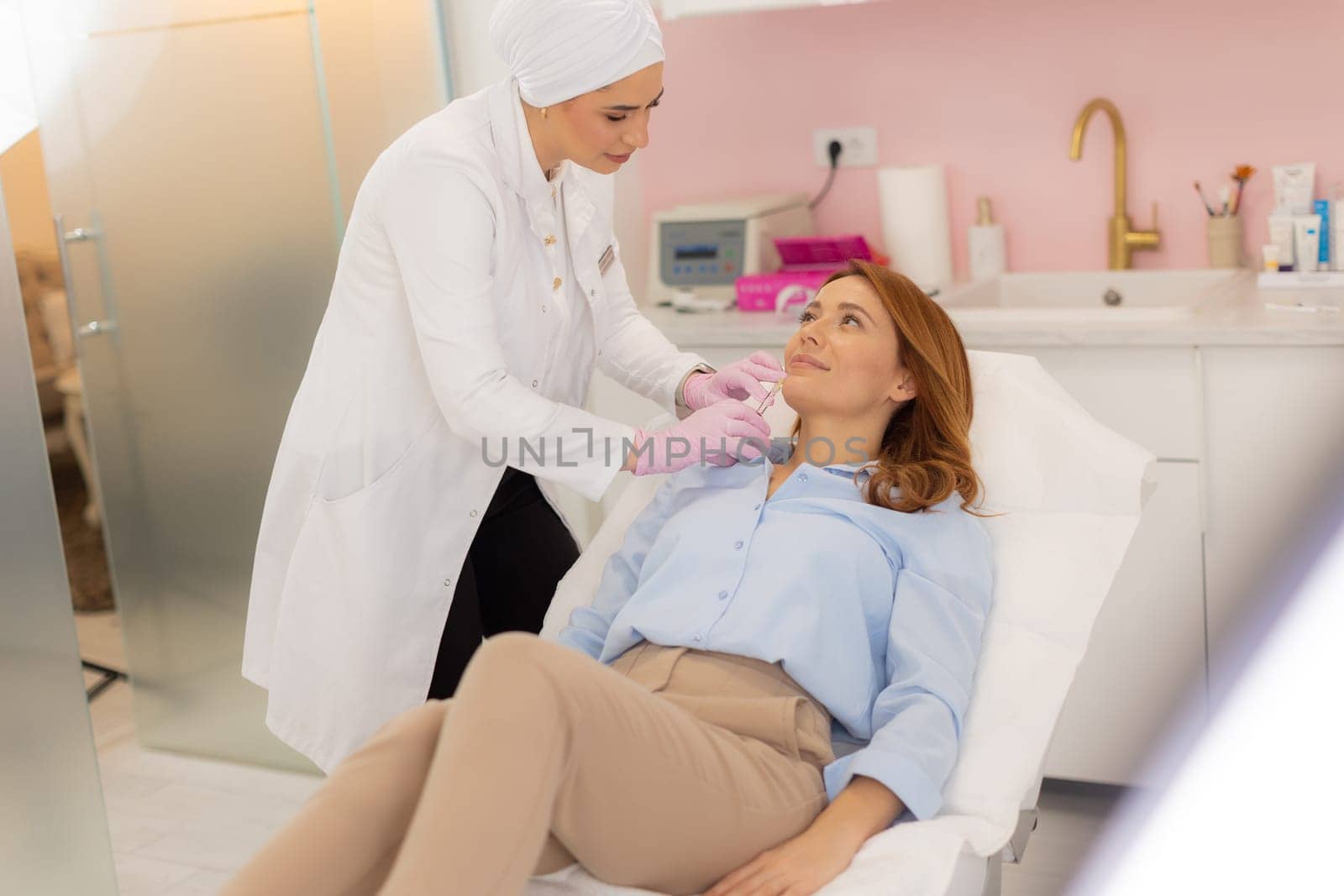 A skilled professional administers a cosmetic treatment to a relaxed client in a calming clinic setting. The atmosphere is tranquil, promoting rejuvenation and self-care.