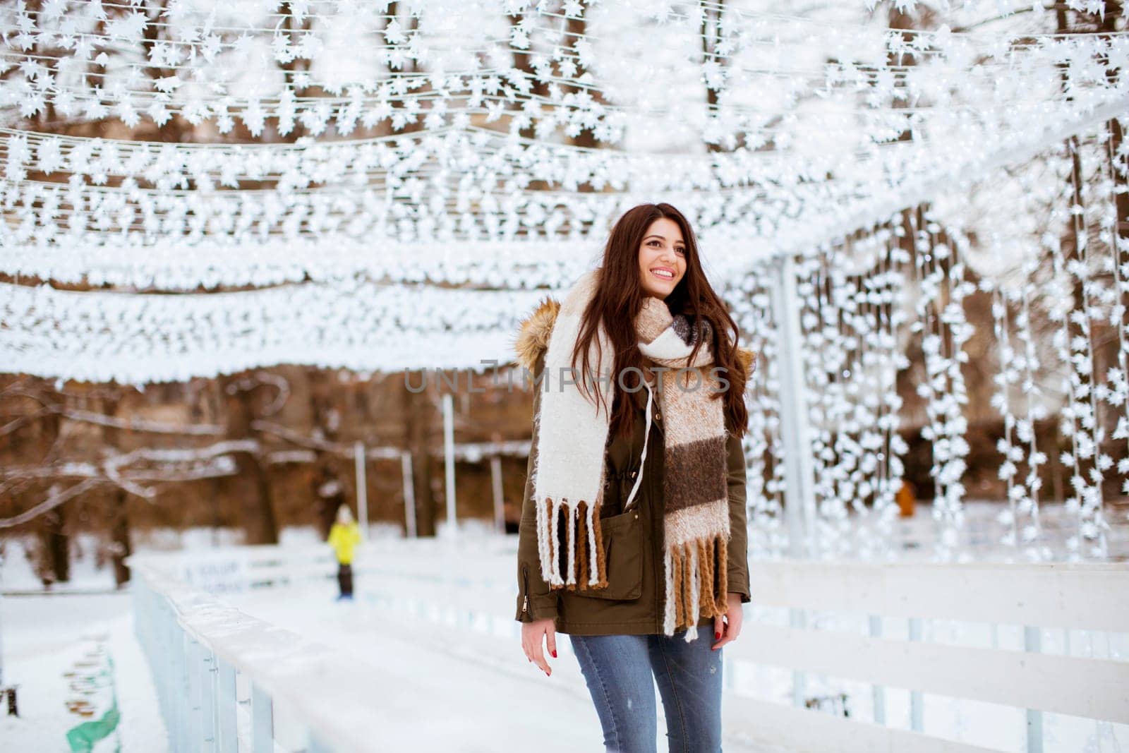Portrait of young woman in winter park at Christmas market