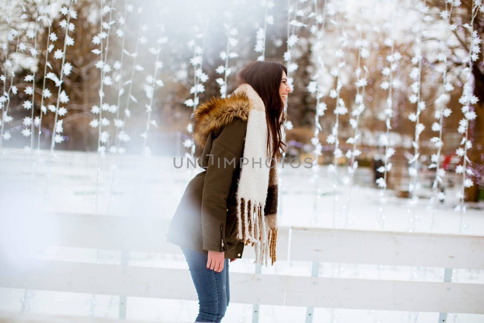Portrait of young woman rides ice skates in the park