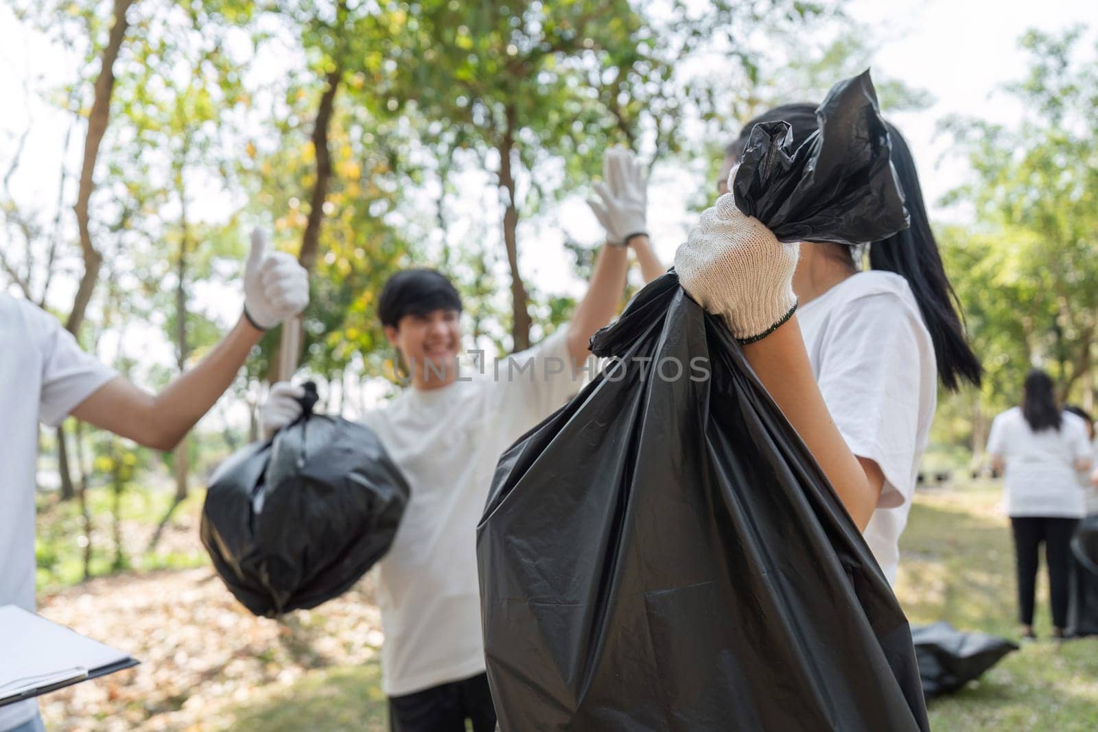 Volunteers celebrate their successful waste collection during a community cleanup event, showcasing teamwork and environmental commitment.