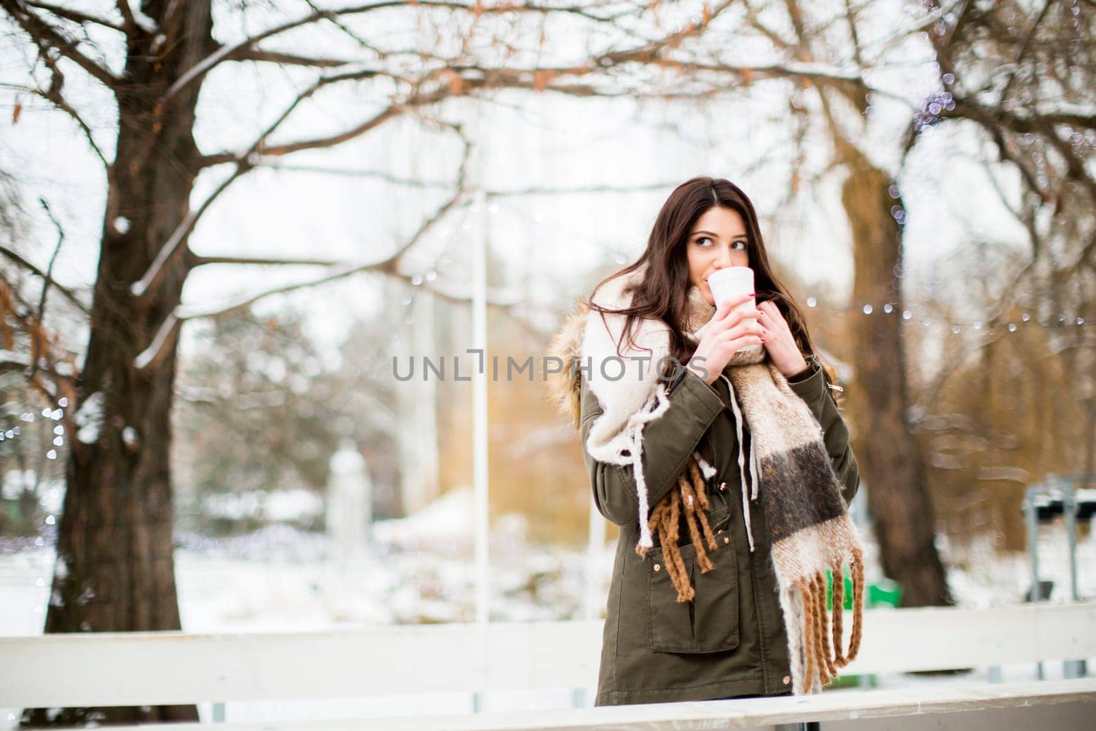 Pretty young woman drinking hot tea on a cold winter day