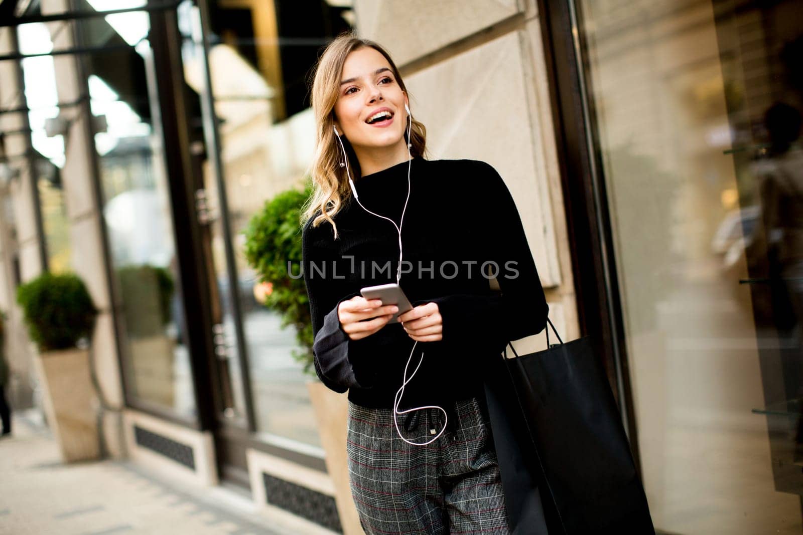 Portrait of young woman  listening music outdoor