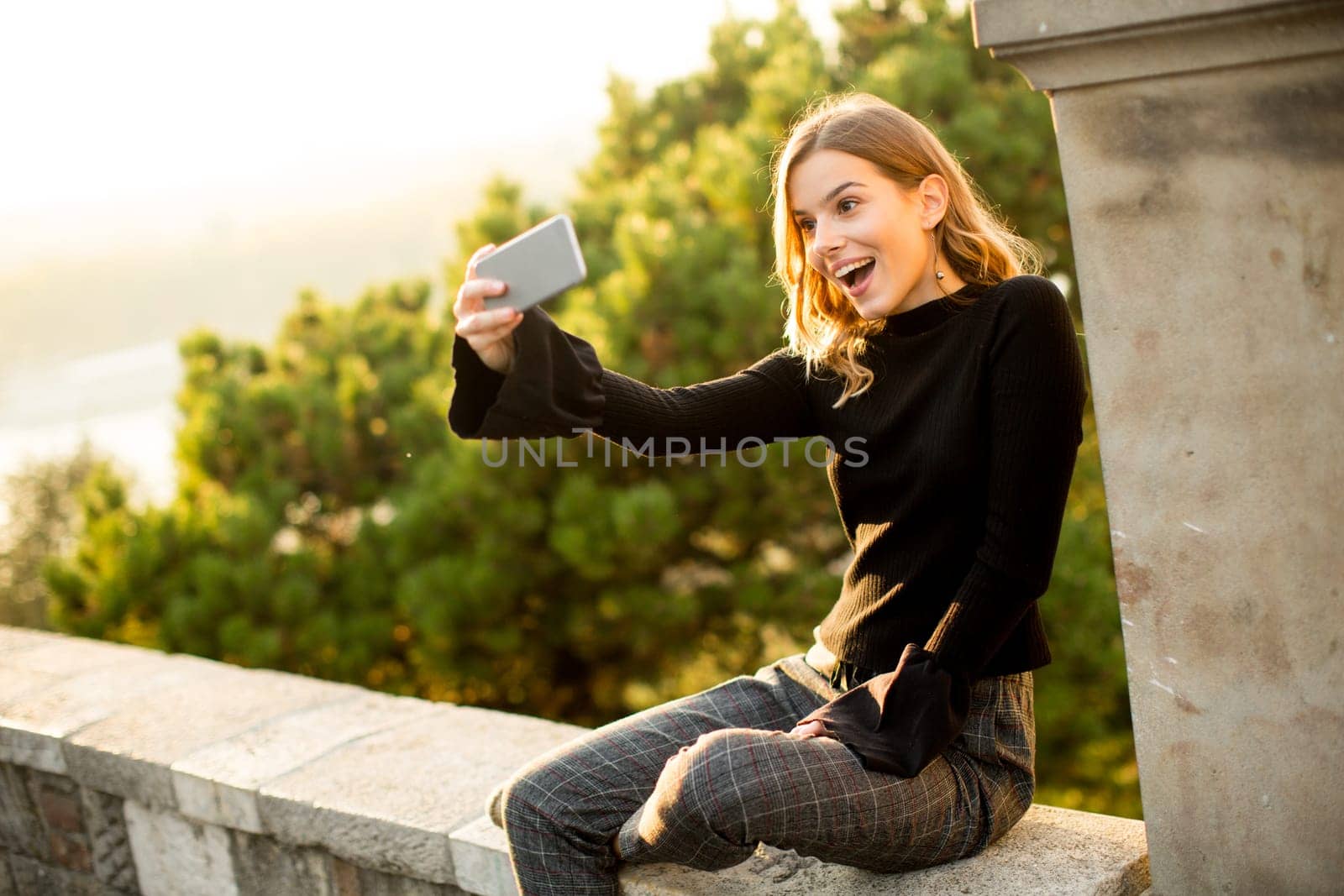 Pretty young woman teking selfie outdoor