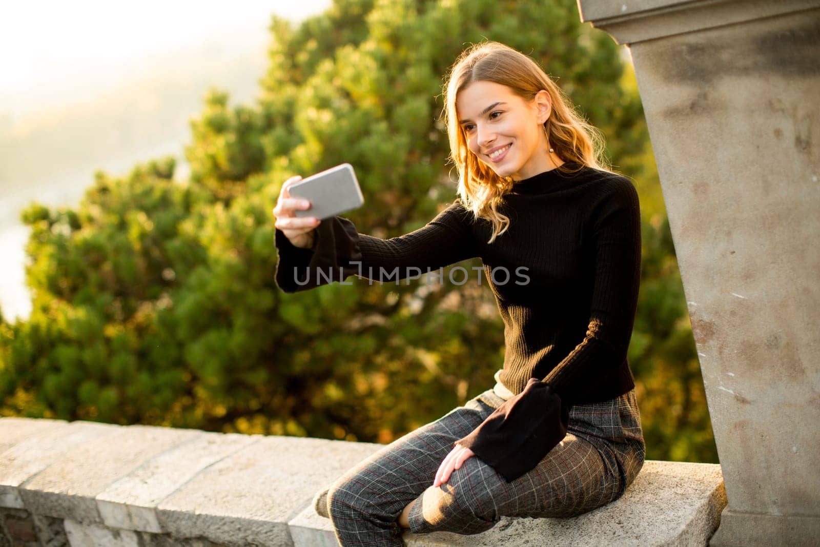 Pretty young woman teking selfie outdoor