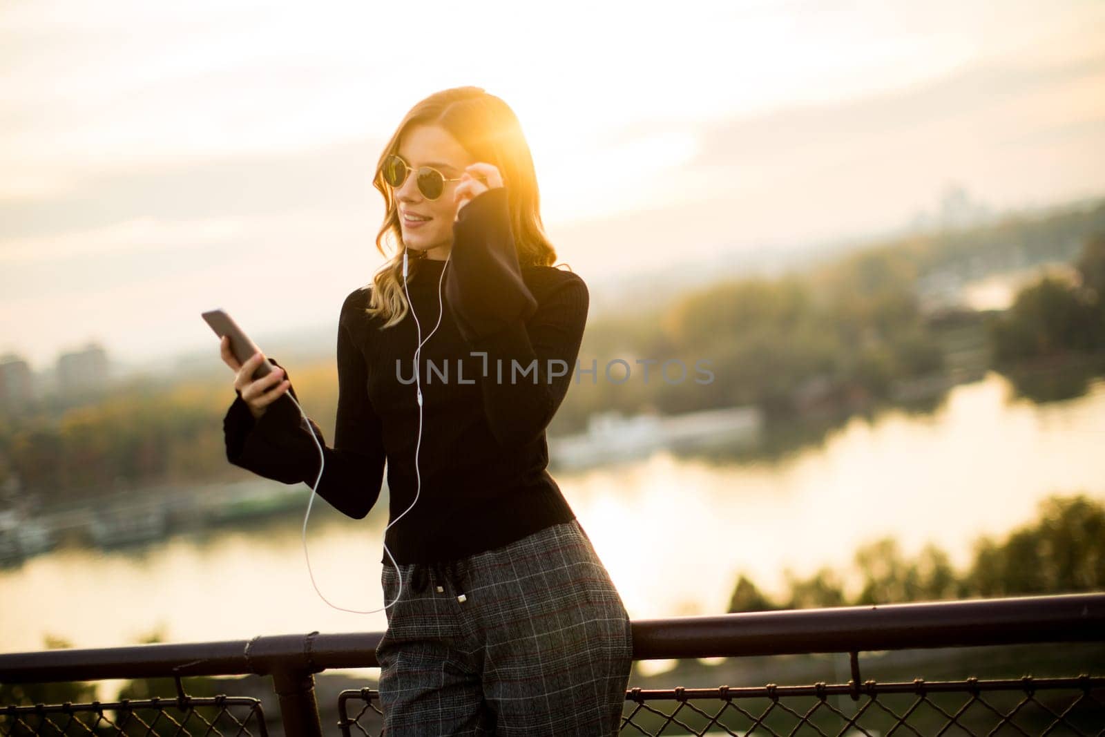 Portrait of attractive young woman with mobile phone outdoor
