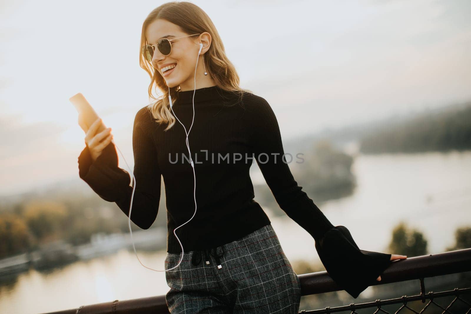 Portrait of attractive young woman with mobile phone outdoor