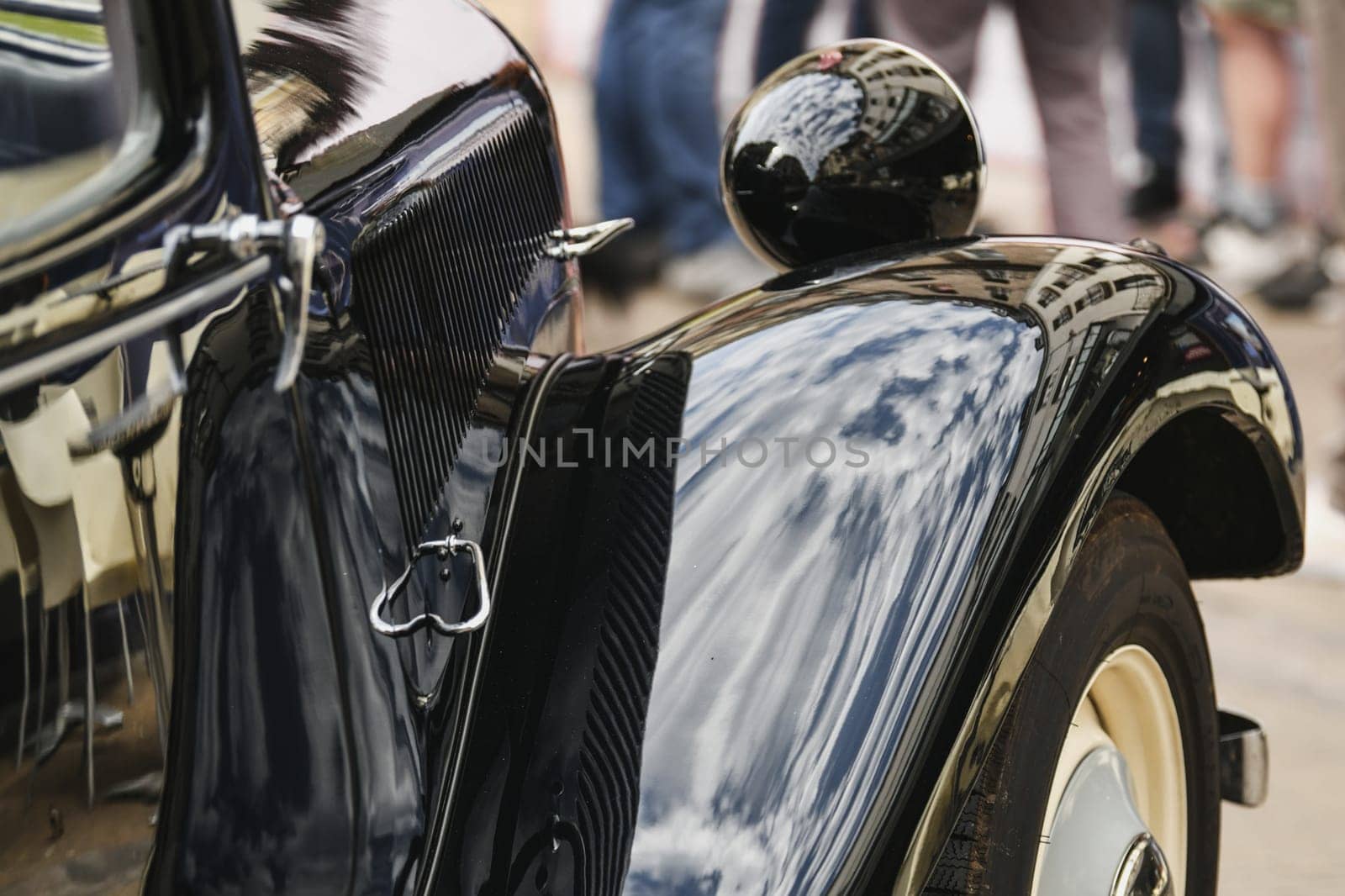 Close up. Macro. Detail of an old vintage black car. Shiny hood, wheel