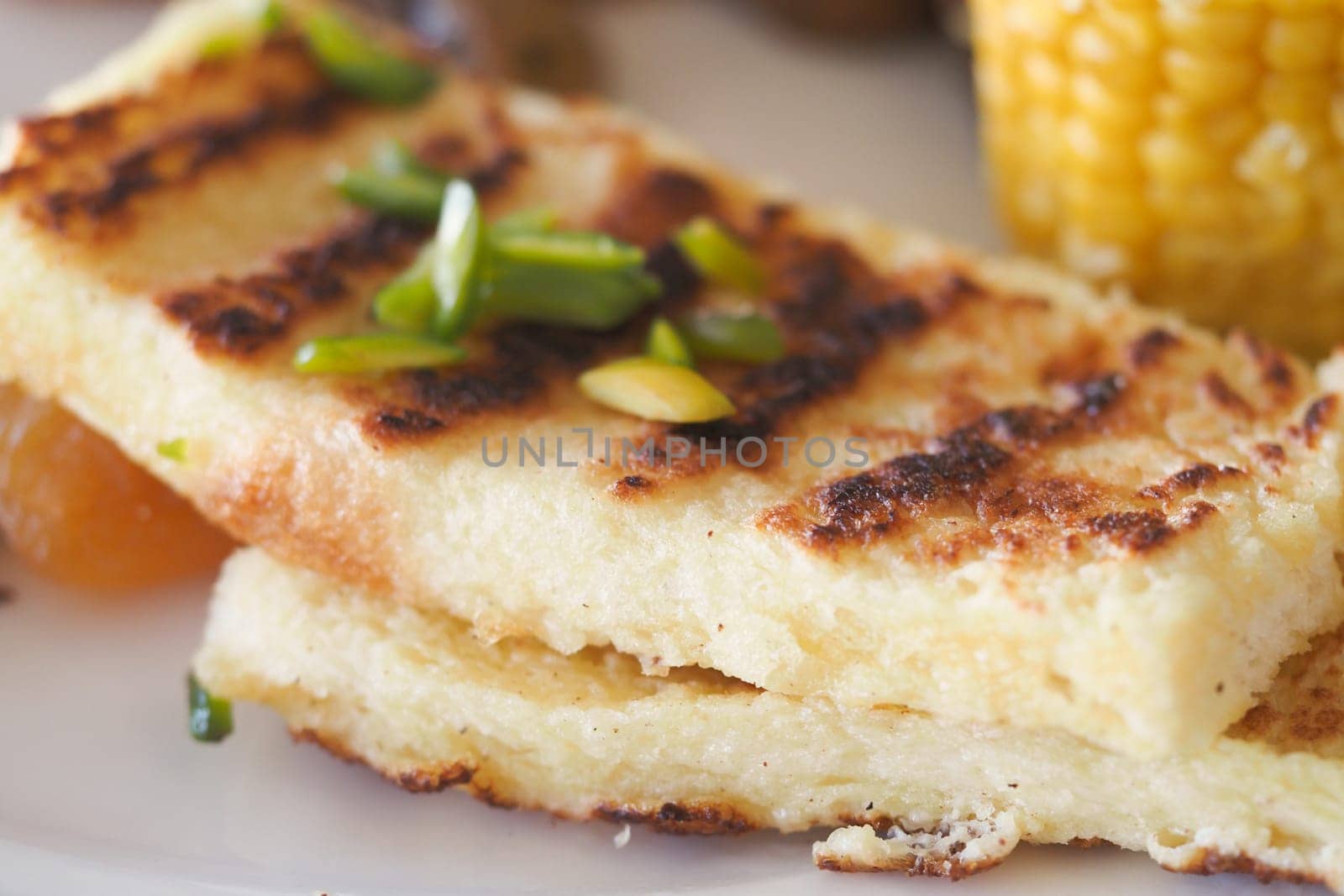 Grilled Bread Slices Garnished with Herbs and Served on a Decorative Plate.