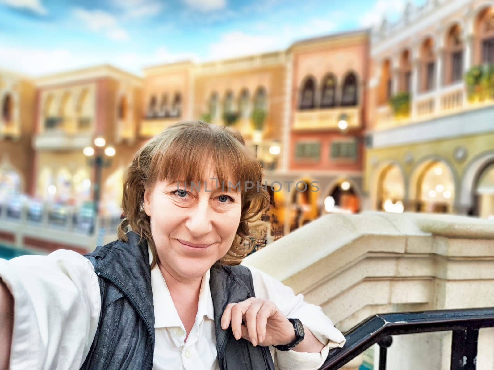 A visitor enjoys the vibrant atmosphere of Macau's famous casino area, full of excitement and stunning architecture.