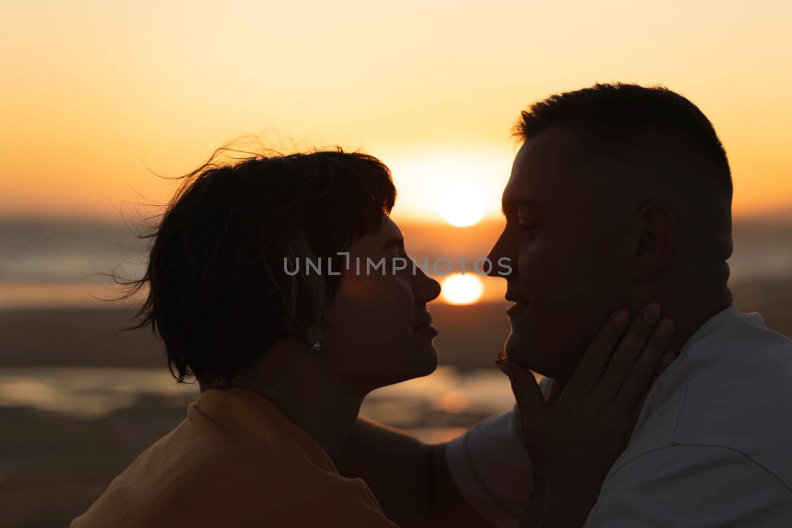Couple enjoying a romantic moment together on the beach at sunset