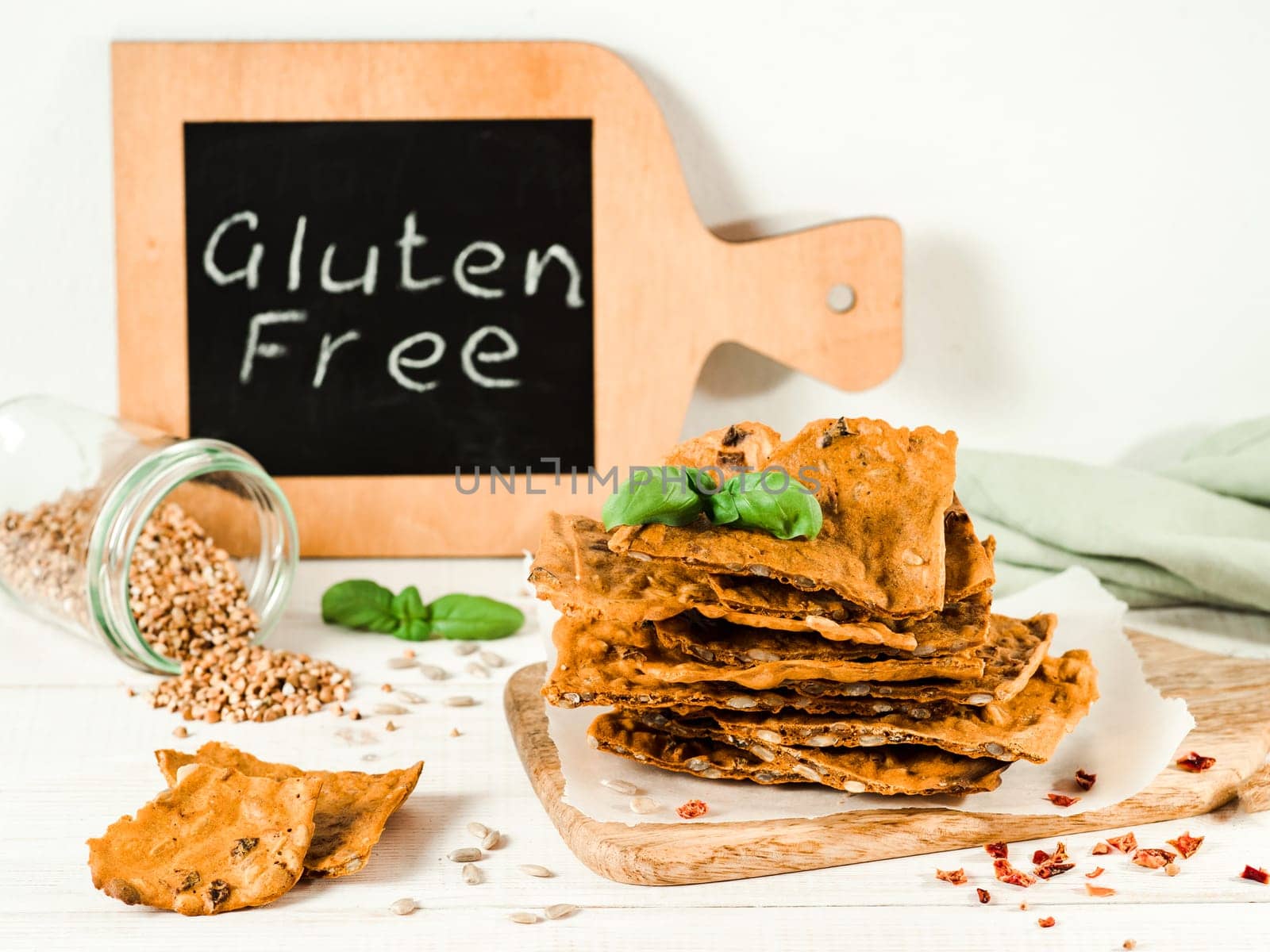 Gluten-freen crispbreads made from buskwheat flour. Green buckwheat flour, smoked paprika, sunflower seeds is ingredients for this homemade baked crisp bread. Idea recipe snacks, gluten-free concept