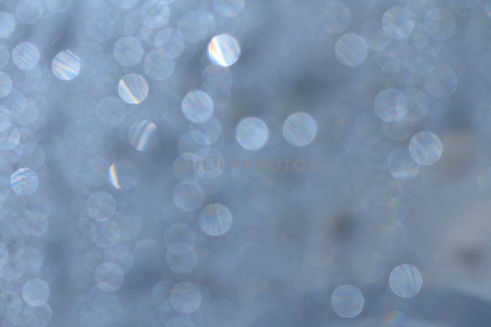 Sunlit droplets dance on calm water, casting enchanting reflections that evoke tranquility.