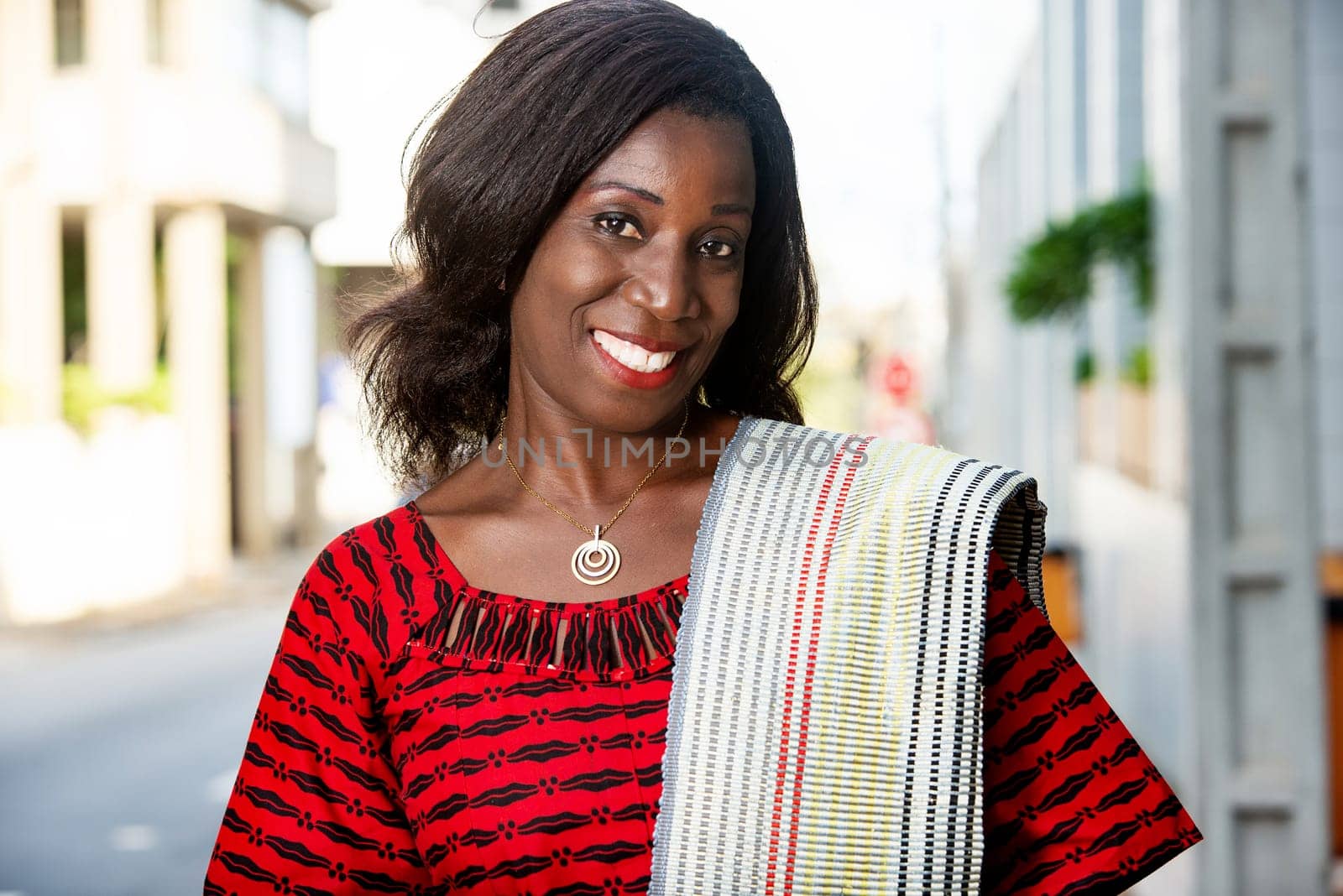 beautiful black haired adult business woman dressed in red loincloth with a shoulder scarf on isolated background smiling in love