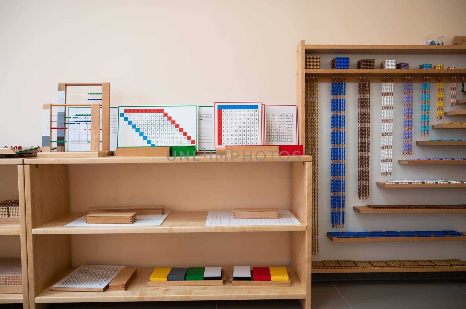 Montessori material. Wooden shelf with materials for Montessori studies
