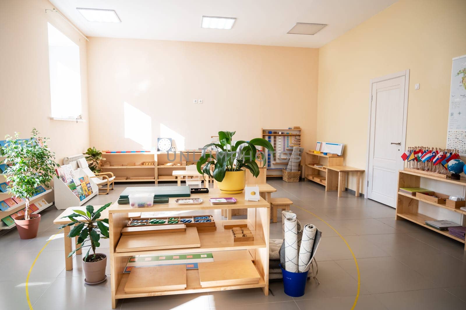 Montessori material. Wooden shelf with materials for Montessori studies