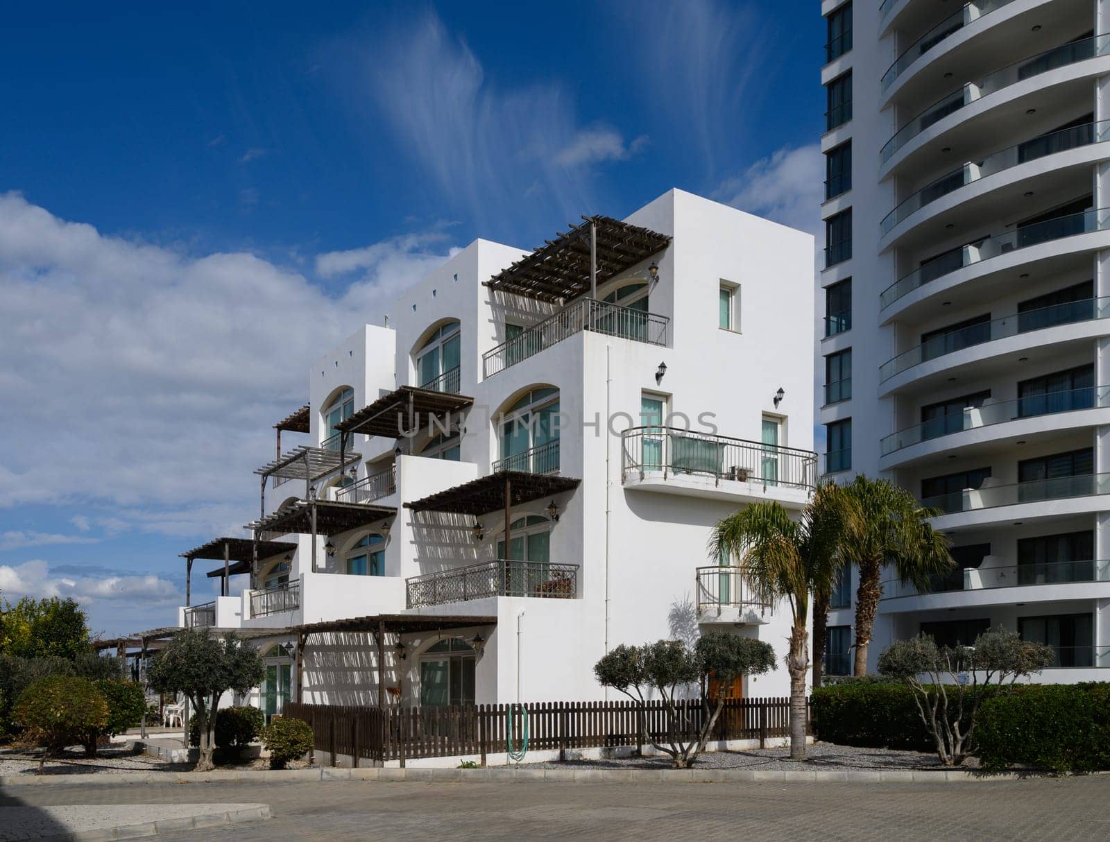 Bright white buildings stand elegantly against a vibrant sky, embodying contemporary style and serene architecture.