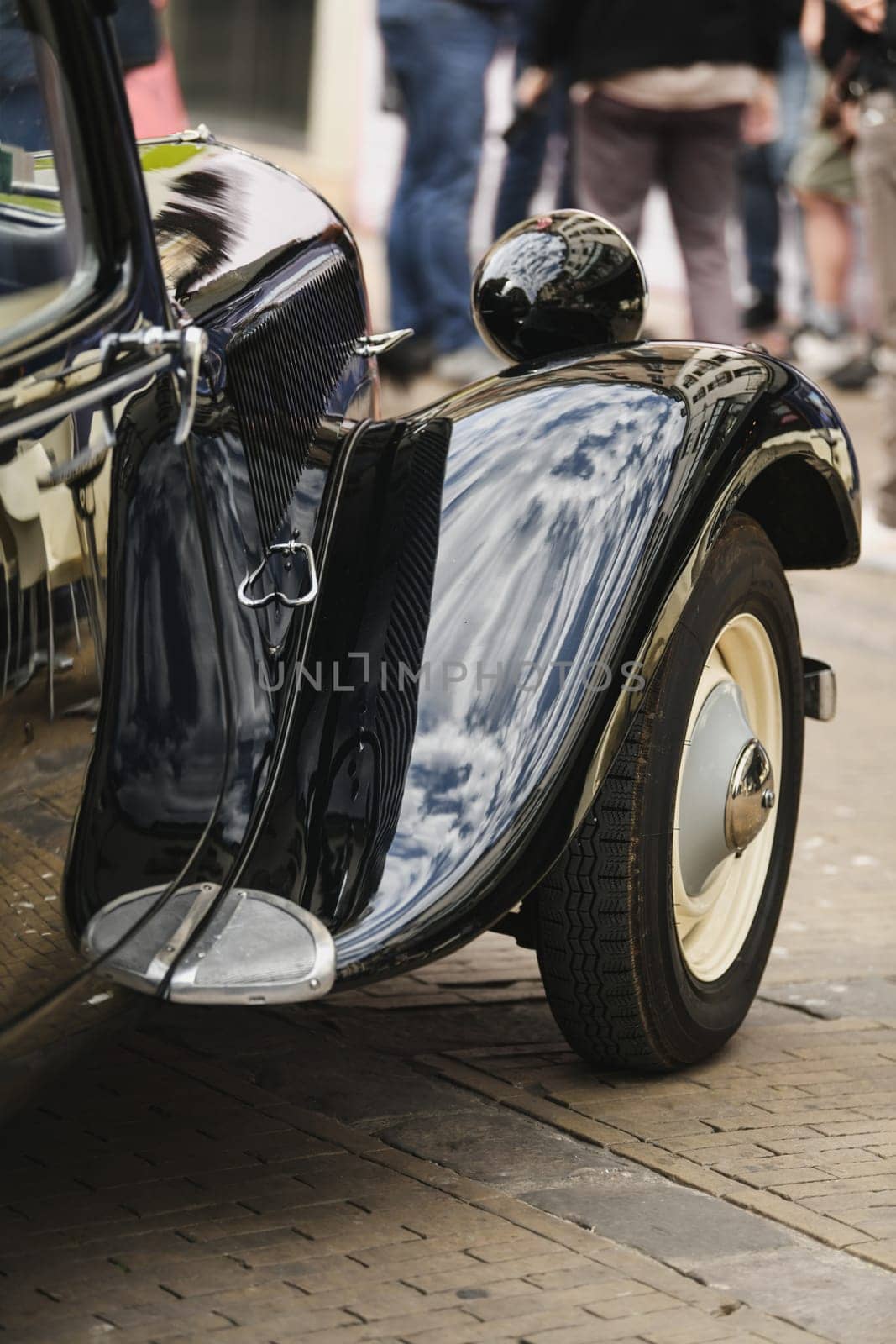 DIEPPE, FRANCE - MAY, 15, 2022: Detail of an old black Citroen Traction Avant. Shiny hood, wheel