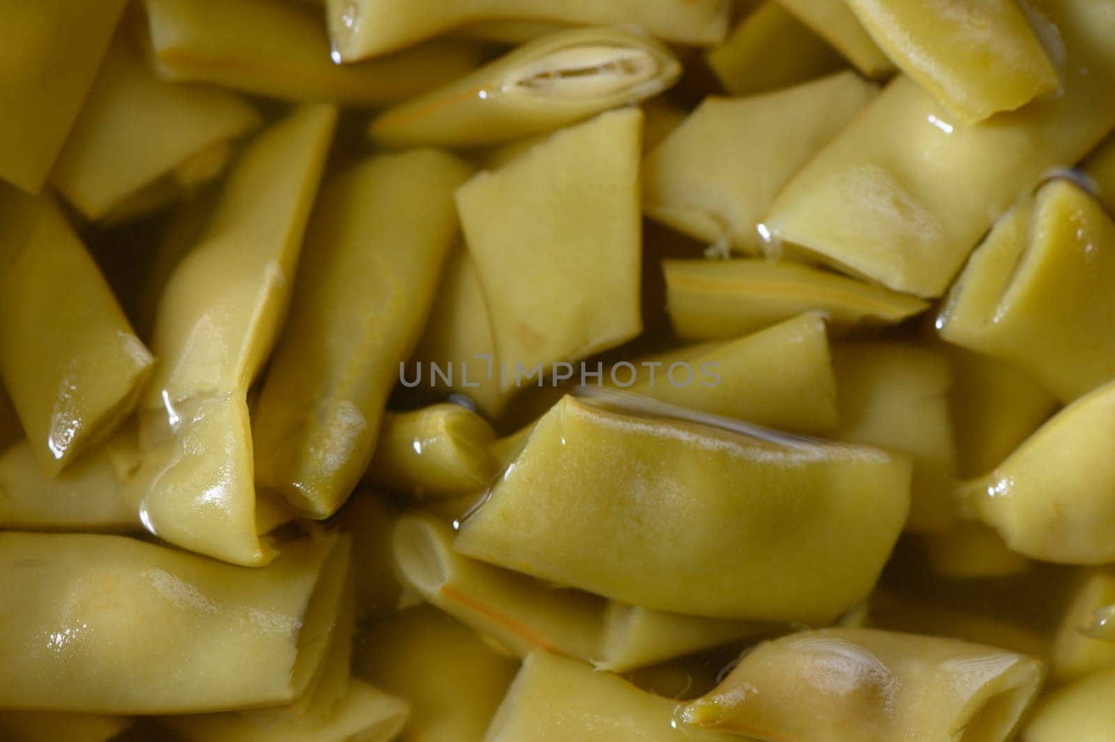 Colorful, tangy pickled vegetable strips rest in a vibrant brine, showcasing culinary craftsmanship and freshness.