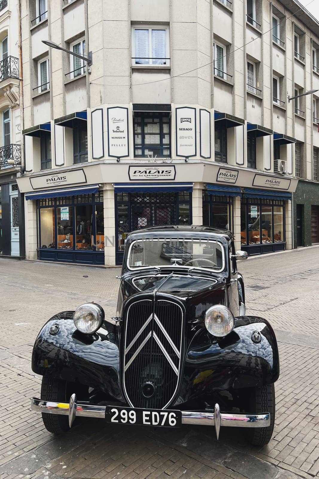 DIEPPE, FRANCE - MAY, 15, 2022: Detail of an old black Citroen Traction Avant. Shiny hood, wheel