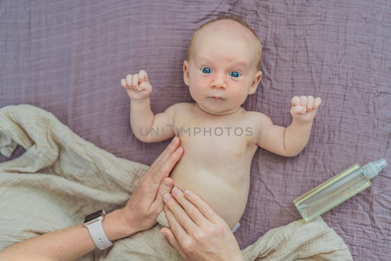 A mother gently massages her 1-month-old baby with baby oil after a bath. This tender moment highlights the bond between parent and child, promoting relaxation, baby care, and the importance of skin-to-skin contact.