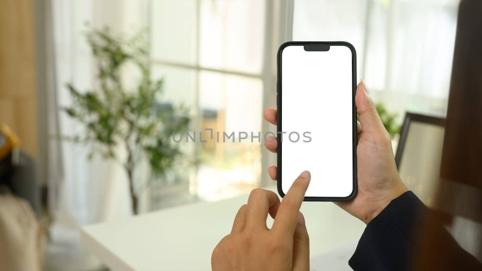 Close up woman holding smartphone with a blank white screen.