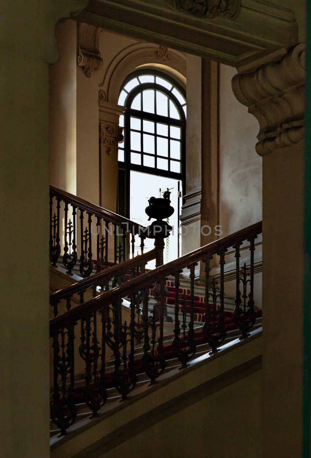 Bangkok, Thailand - Mar 02, 2025 - Vintage staircase railing or stairway banister leading into hallway on the 2nd floor with open casement window of Bang Khun Phrom Palace or Bank of Thailand Museum. use it as your Wallpaper, Poster and Space for text, Selective focus.