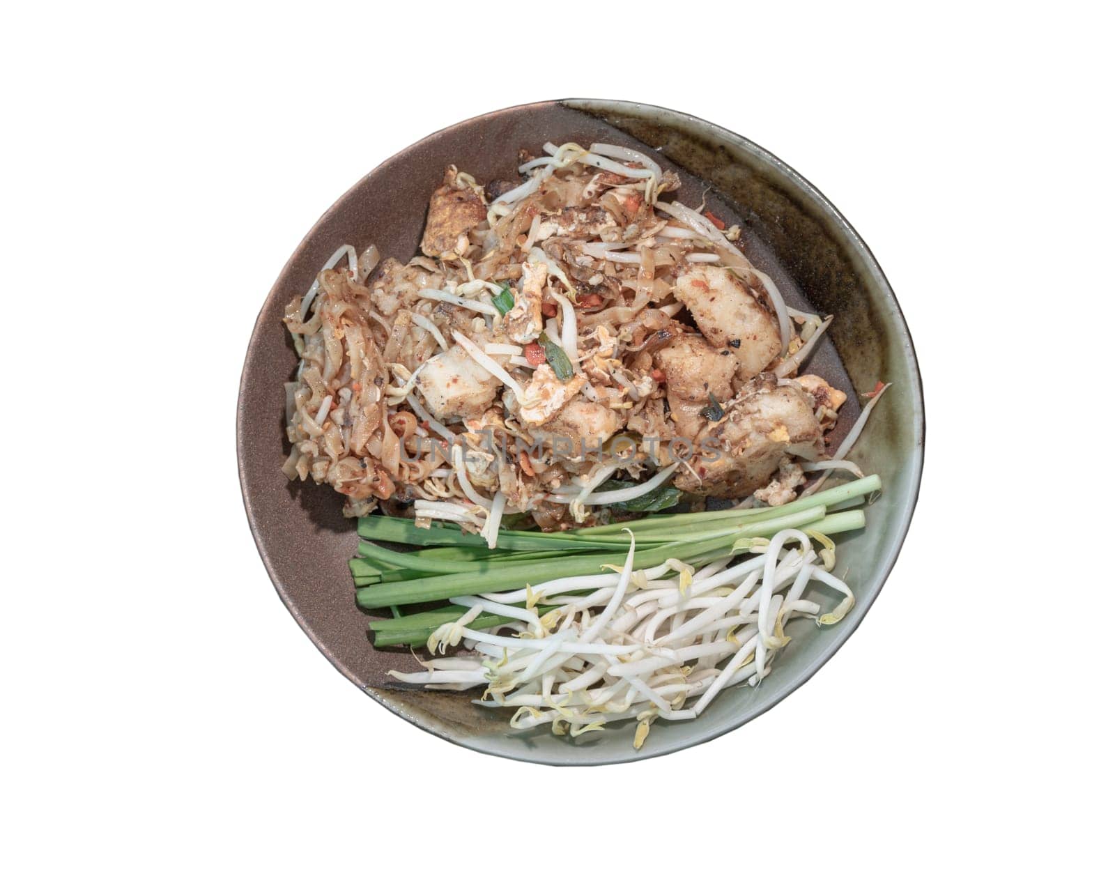 Traditional fried thai noodle (pad thai) mix Stirred fried turnip cake or Fried radish cake (chai tow kway) served with bean sprout and chives in ceramic plate isolated on white background with clipping path. Selective focus.