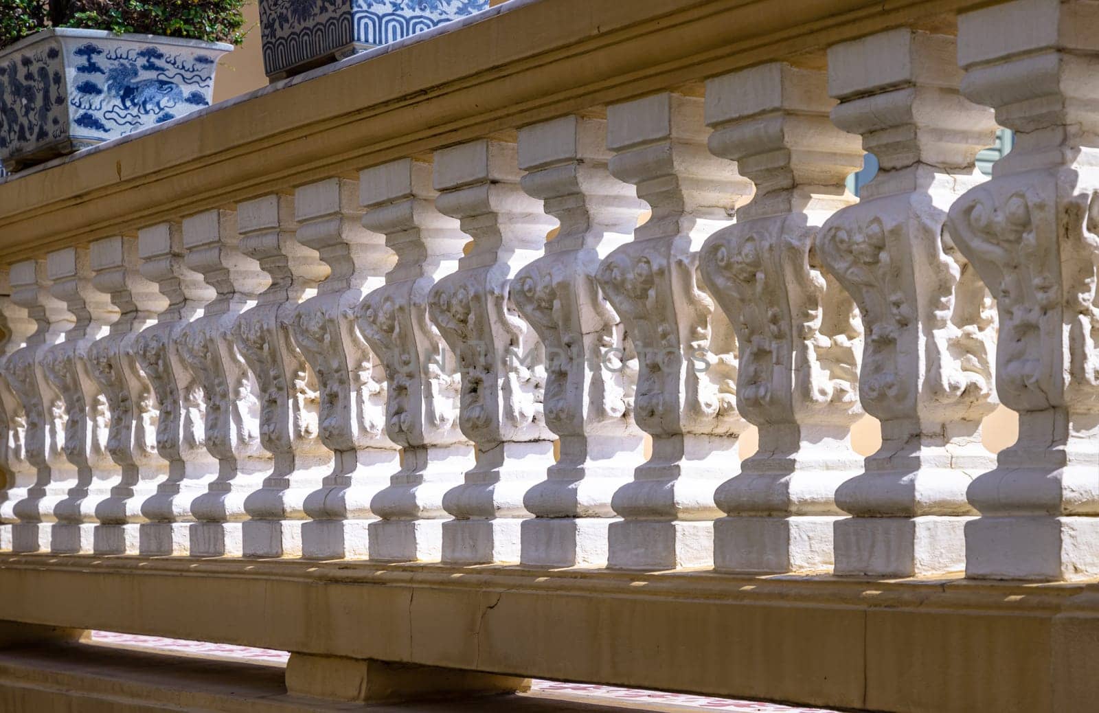 Bangkok, Thailand - Mar 02, 2025 - The morning light shining through Row of Vintage concrete railings or Ornate cast stone balustrades in classical style. Architectural element of precast concrete, use it as your Wallpaper, Poster and Space for text.