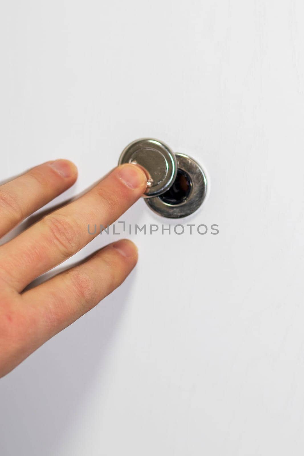 Man opening the door peephole