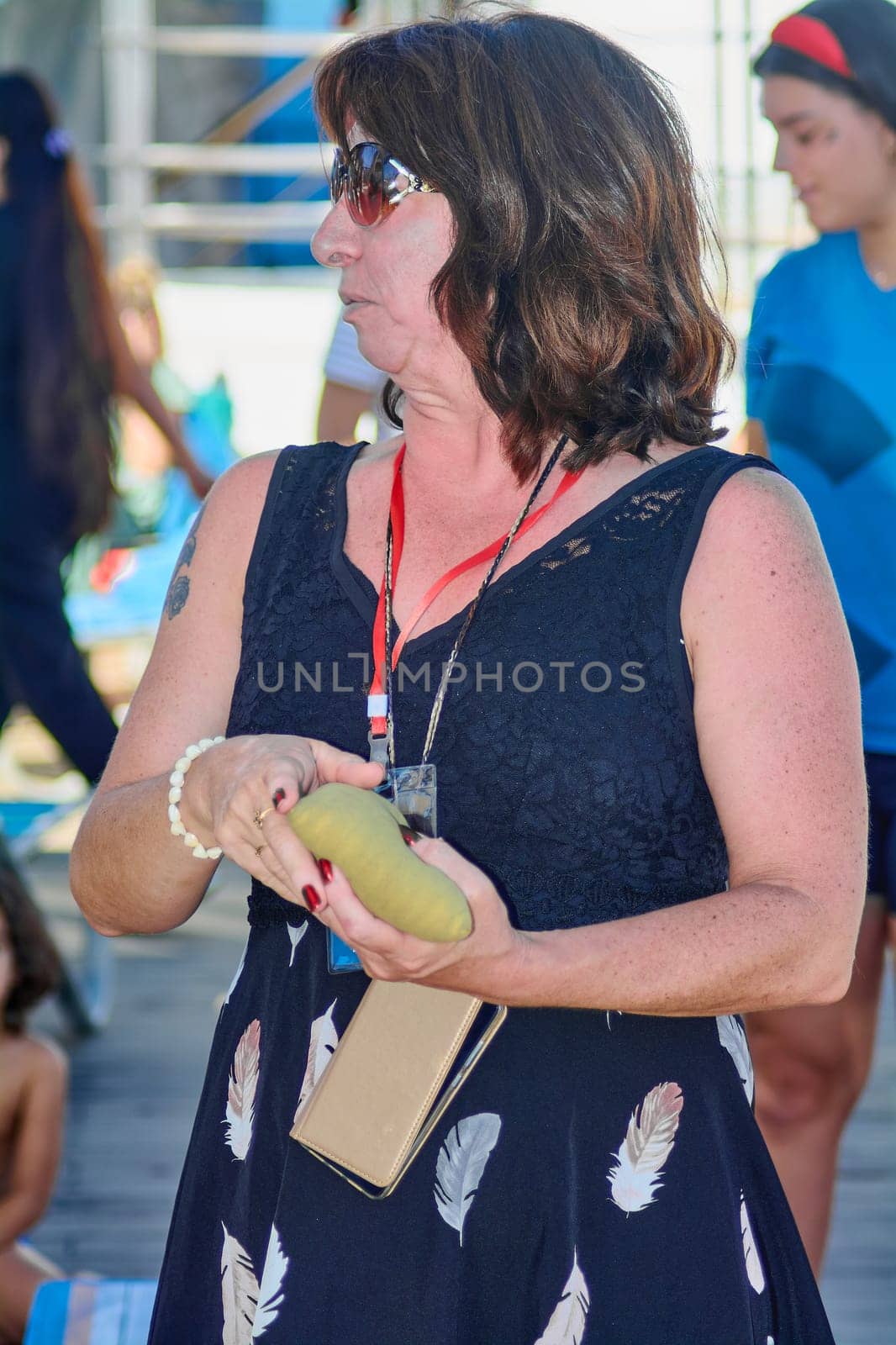 Catania. Italy - March 11, 2025: Concentrated player holding a beanbag while preparing to throw, showcasing the recreational spirit of cornhole in a vibrant outdoor setting.