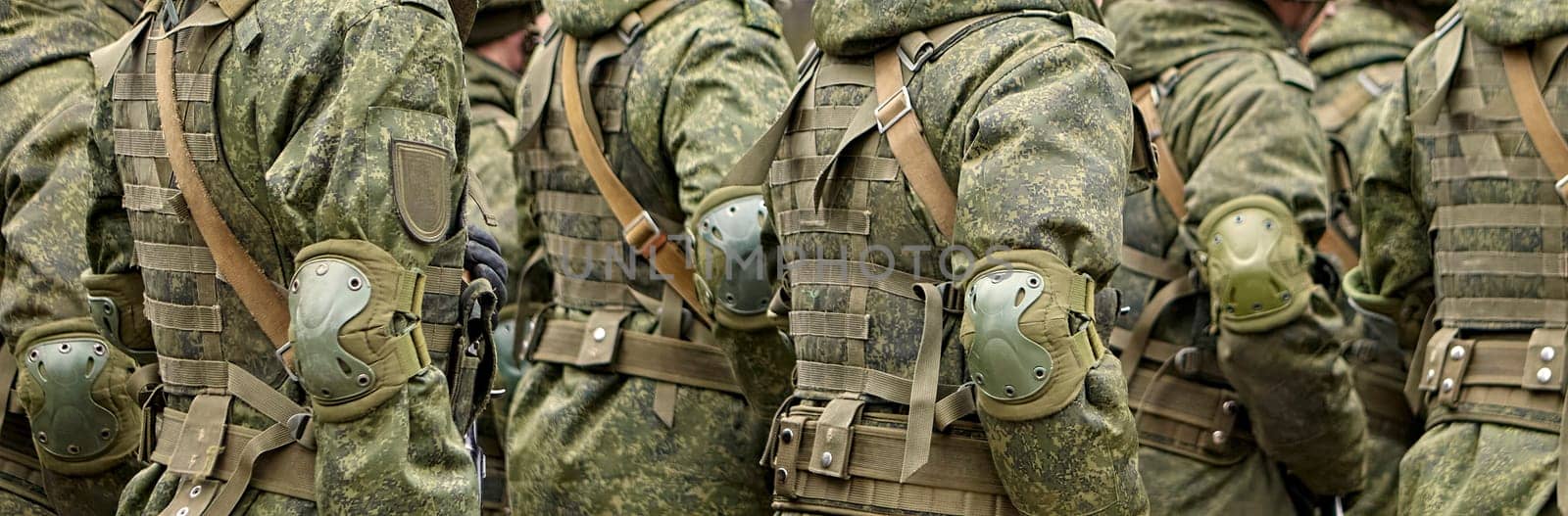 Military personnel engage in a training exercise, showcasing their skills and coordination in tactical formations amidst a clear day.