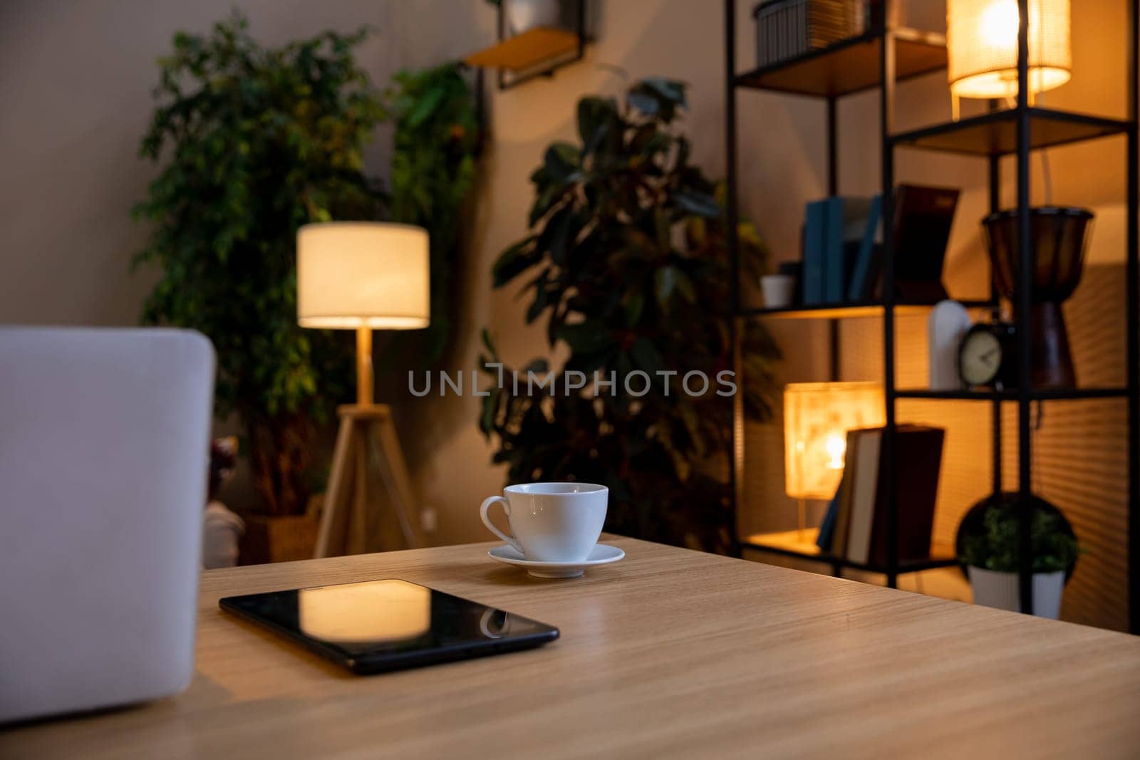 A stylish and inviting home office scene showcases warm lighting that fosters a calming and serene atmosphere