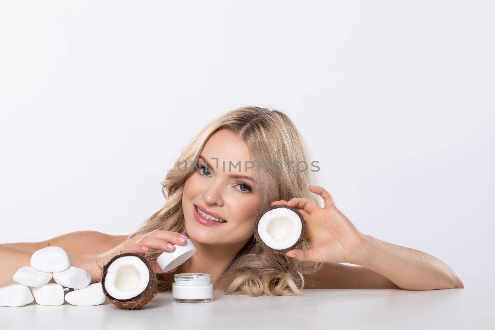 A smiling woman enthusiastically promoting a luxurious line of skincare products featuring natural ingredients