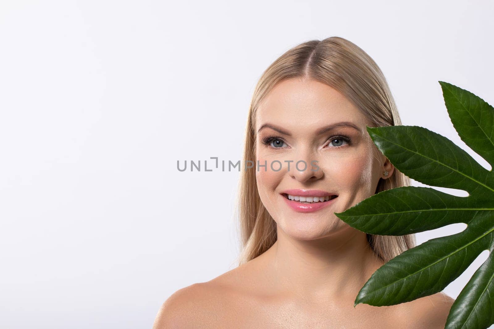 A captivating model showcases natural elements in innovative beauty and skincare, inspiring holistic wellness