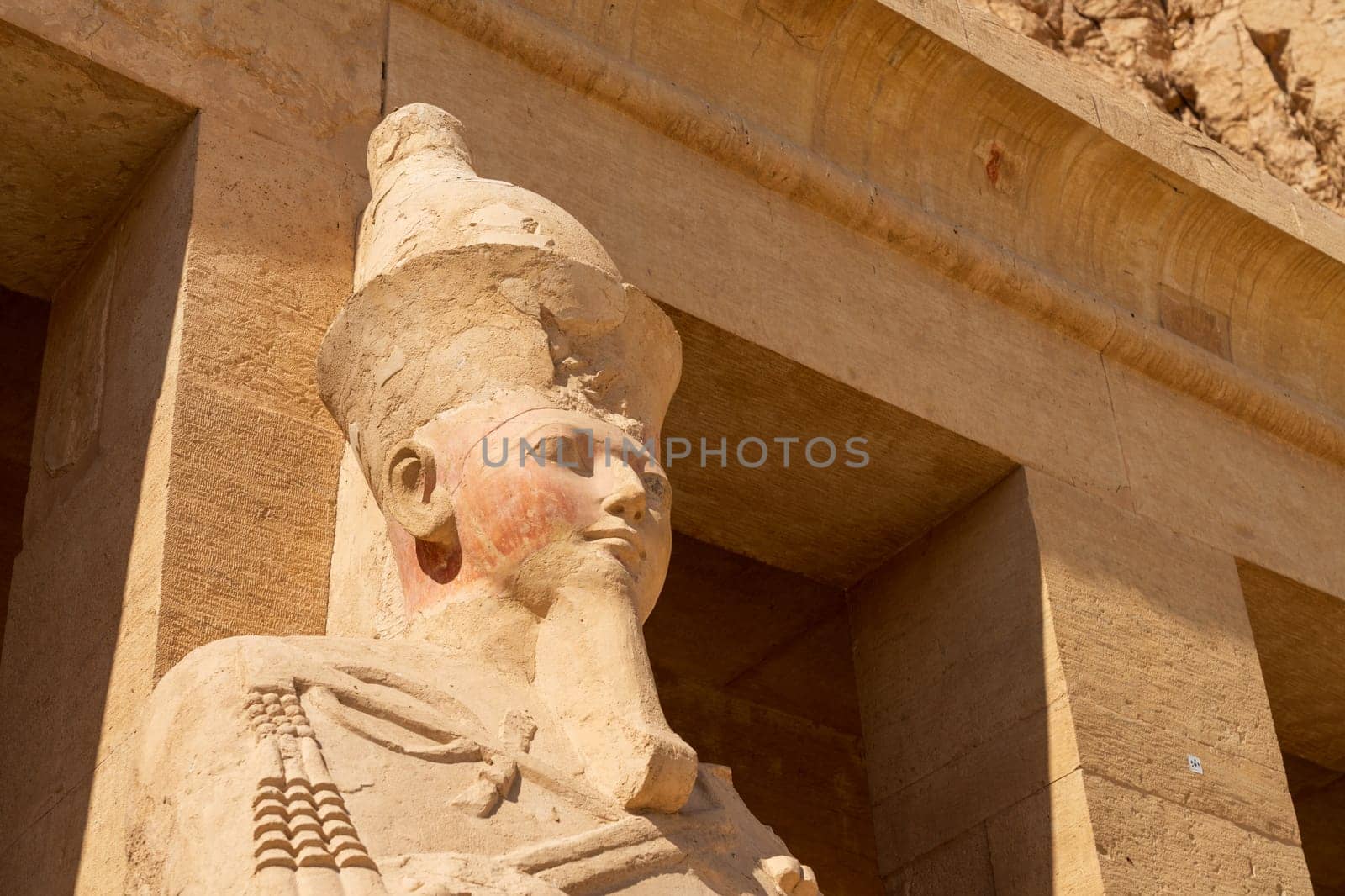 Large statue of head of pharoah at Hatshepsut Temple near Luxor Egypt by the columns of the Mortuary