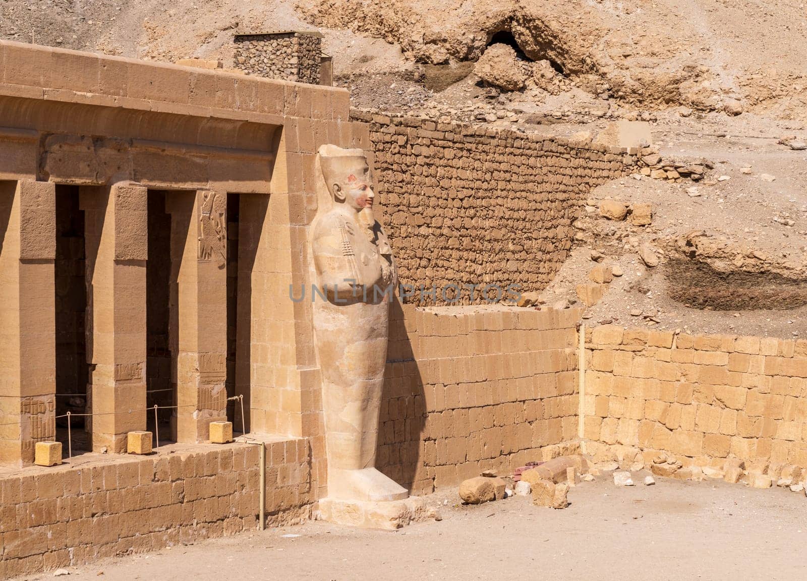 Large statue of pharoah at Hatshepsut Temple near Luxor Egypt by the columns of the Mortuary