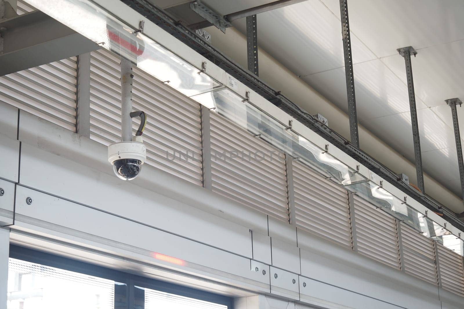 A security camera is positioned on the ceiling, overseeing the area.