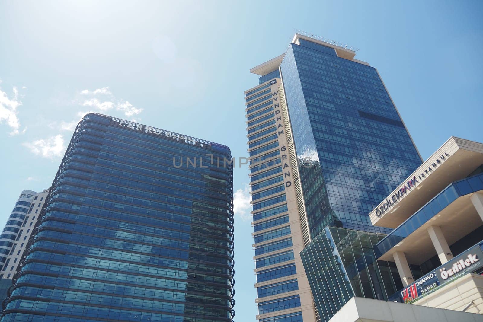 Two impressive skyscrapers stand tall against a clear blue sky.