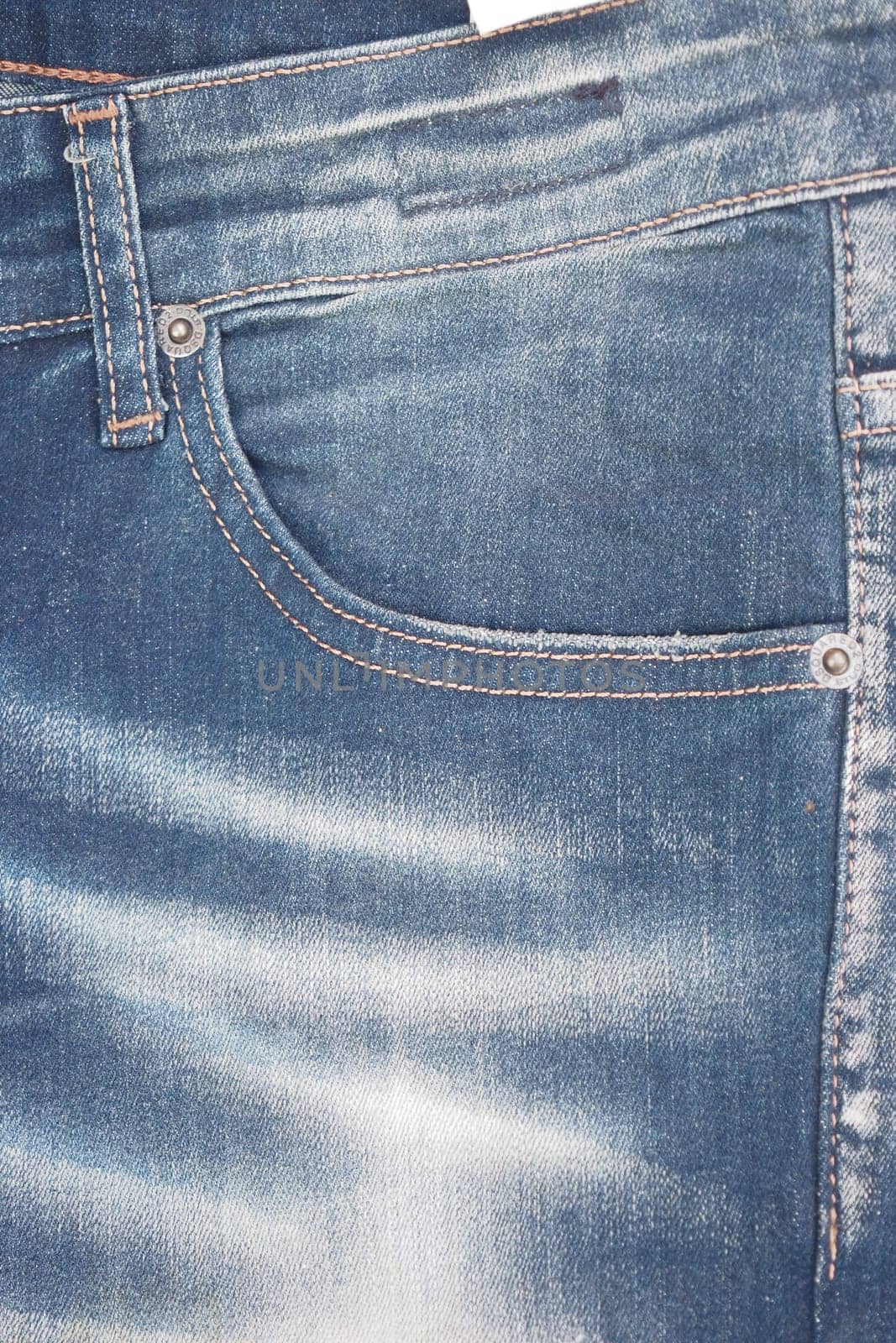 Close-up view of denim jeans featuring a trendy fade and pockets.