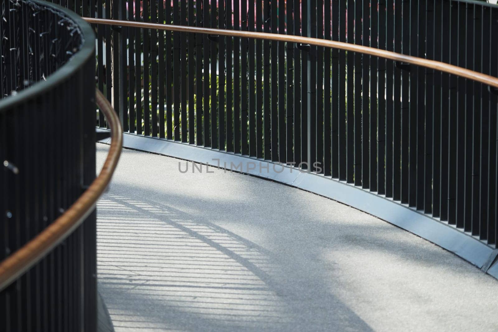 Smooth walkway with railing fosters tranquility in urban spaces.
