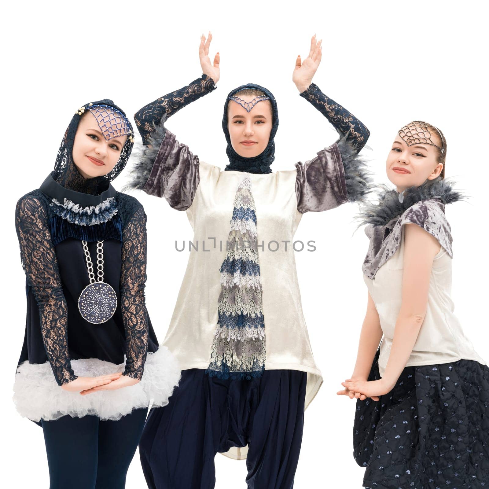 Women in creative outfits display unique styles and poses with artistic flair in a bright indoor space that highlights their individuality.